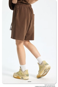 Detail of brown vintage cotton shorts featuring elastic drawstring waist and side pockets