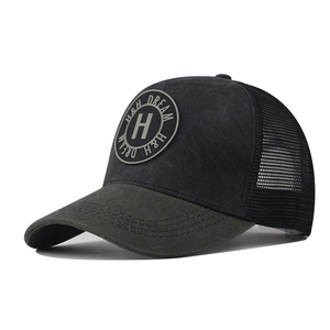 Close-up of trucker hat showing H embroidery, mesh back, and olive green brim detail