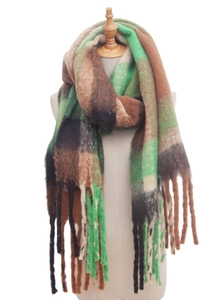 Close-up of winter thick oversized checkered scarf with long fringes in green and brown