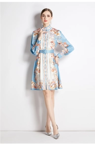 Detail of floral printed shirt dress featuring a stand collar and matching waist belt