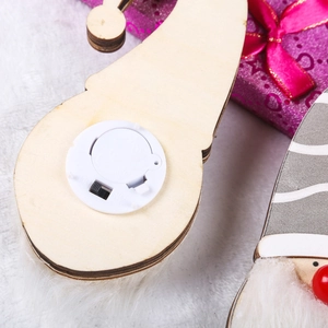 Detail view showing the battery compartment and ON/OFF switch of the glowing wooden Santa pendant