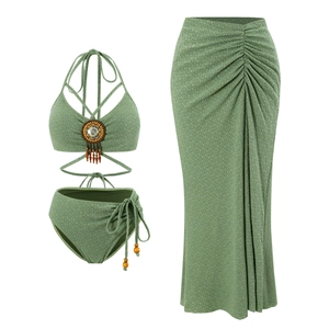 Detail of sage green bikini set with bohemian tassels and textured seersucker fabric