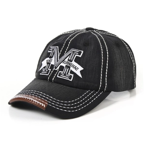 Denim baseball cap with letter M embroidery and brown leather brim, 45-degree view