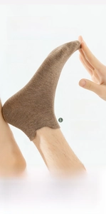 Detail of coffee brown ankle sock showing high elasticity Lycra fiber and heel tab