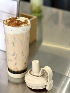 Close-up of clear Tritan boba cup with magnetic handle and wide straw for pearl milk tea