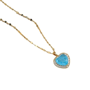 Golden wafer chain necklace with blue heart-shaped pendant and halo of white stones