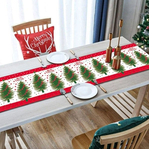 Christmas table runner with Merry Christmas text and festive tree pattern on table