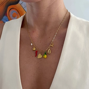 Gold multi-charm necklace with pearl, heart, chili, and shell pendants on model