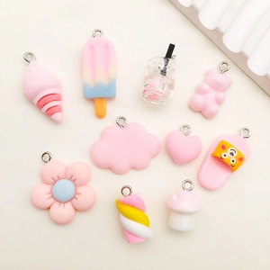 Pink resin pendants assortment including ice cream, bears and clouds for DIY crafts