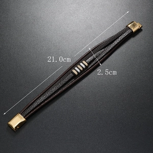 Detail view of multi-layer black leather bracelet with gold beads and size markers