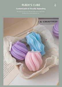 Three colorful geometric spiral soy wax candles in a sustainable pulp gift box