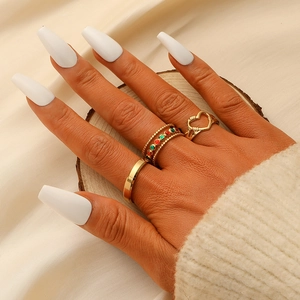 Three-piece gold-tone titanium steel ring set with hollow heart and colorful bead accents