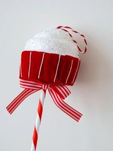 Detailed Christmas cupcake ornament featuring white glitter frosting and red velvet texture