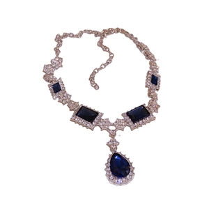 Elegant silver chain necklace with square blue gemstones and clear crystal accents