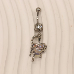 Macro view of silver heart navel ring with crystal gem and melted texture detail