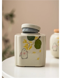 Detail of square ceramic tea canister with hand-painted rabbits and osmanthus pattern