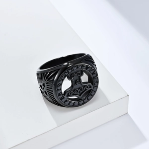 Men's black Viking Mjolnir ring in stainless steel displayed on a geometric pedestal