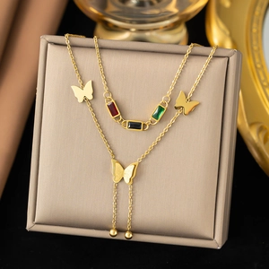 Detail of double-layer gold titanium steel necklace with colorful gems and butterfly charms