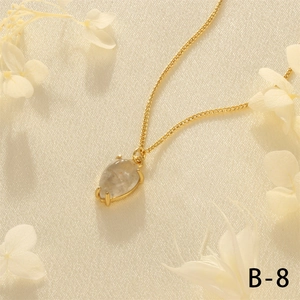 Detail of 18K gold-plated teardrop gemstone pendant on a fine Cuban link chain