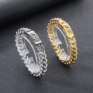 Close-up of vintage engraved clasps on gold and silver keel chain bracelets