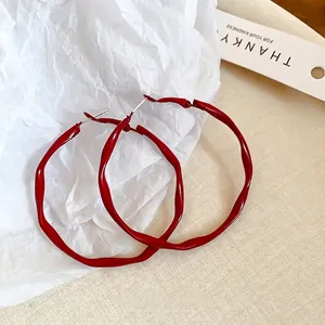 Modern Ancora red twisted hoop earrings for women with irregular textured metal design