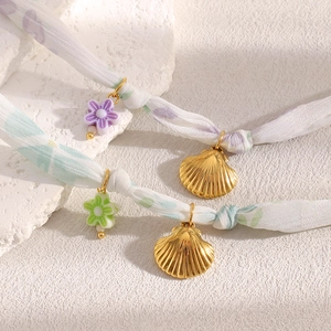 18K gold plated stainless steel ribbon bracelet with shell pendants and floral charms