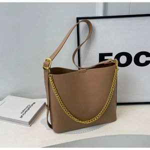 Detail of khaki PU leather shoulder bag featuring a gold chain strap and elegant texture