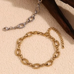 Minimalist 14K gold and silver stainless steel oval link anklet on neutral background