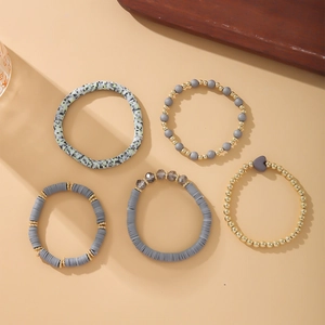 Detail of 5-piece Bohemian bracelet set with grey heishi beads and golden spacers