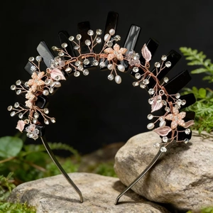Macro detail of crown headband with pink flowers and crystals on mossy rock