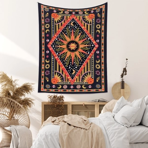 Detailed Bohemian tapestry showing vibrant sun moon stars on black fabric in bedroom