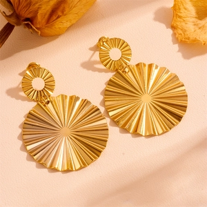 Macro view of gold S925 silver earrings featuring radiant pleated circular texture