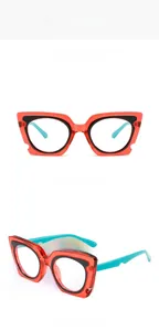 Close-up of red cat-eye frames with blue temples and layered black decorative ring details