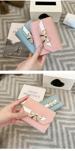 Détail de portefeuilles courts en cuir PU rose et bleu avec un nœud doré élégant
