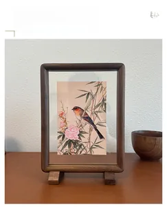 Macro detail of black walnut wood frame showing double-sided glass for Chinese paintings