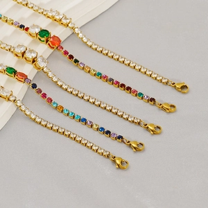 Close-up of golden tennis bracelets with colorful zirconia stones and lobster clasps