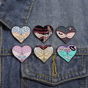 Set of 6 gothic heart enamel pins featuring skull hand and witch motifs on denim jacket