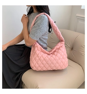 Close-up of pink quilted puffer tote bag with a soft padded texture for daily casual use