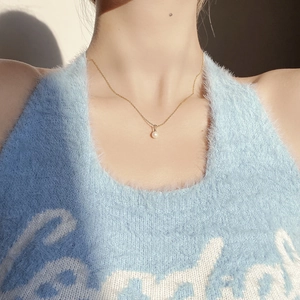 Close-up of minimalist natural freshwater pearl necklace on a model's neck for a dainty look