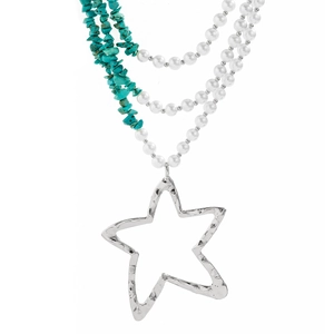 Close-up of bohemian layered necklace with turquoise beads and hammered star charm