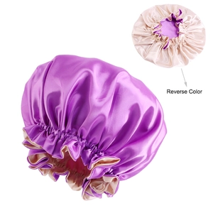 Detailed view of reversible satin sleep bonnet showing purple silk texture and beige lining