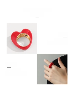 Detail view of 3D red enamel heart ring featuring high-gloss gold metallic inner band