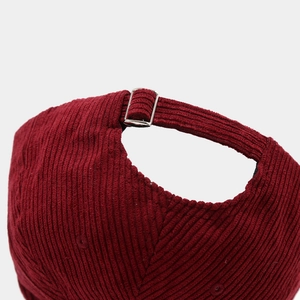 Adjustable back strap of burgundy corduroy baseball cap with metal buckle and stitching