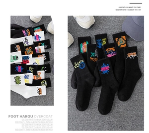 Detail of cotton crew socks featuring colorful street style graffiti embroidery on the ribbed cuff