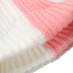 Macro shot of pink and white ribbed knit texture showing soft plush winter hat fabric