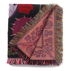 Detail of double-sided jacquard weave with colorful fringes on a bohemian camp blanket