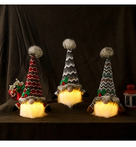 Close-up of three glowing Christmas gnomes in red, grey, and green with LED light effect