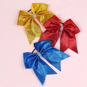 Close-up of glitter hair bows with rhinestones in gold, red and blue colors