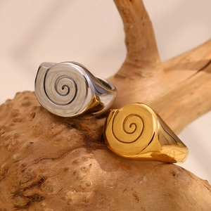 18K gold plated stainless steel signet ring with spiral engraving on natural wood