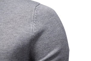 Detail shot of the reinforced shoulder seam on a grey slim fit knitted men sweater